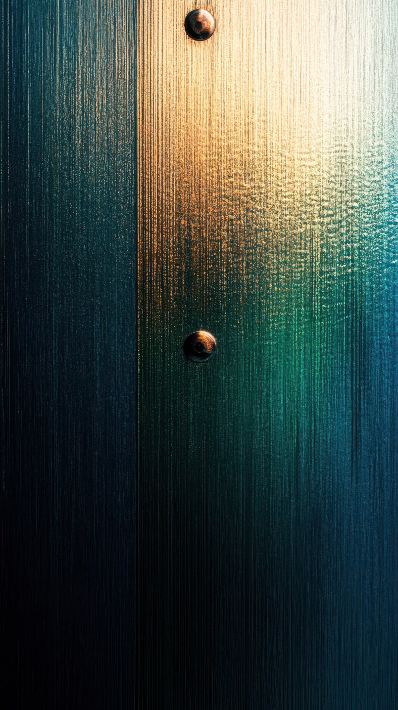 Light filters through a textured glass door showcasing an abstract play of colors at dusk
